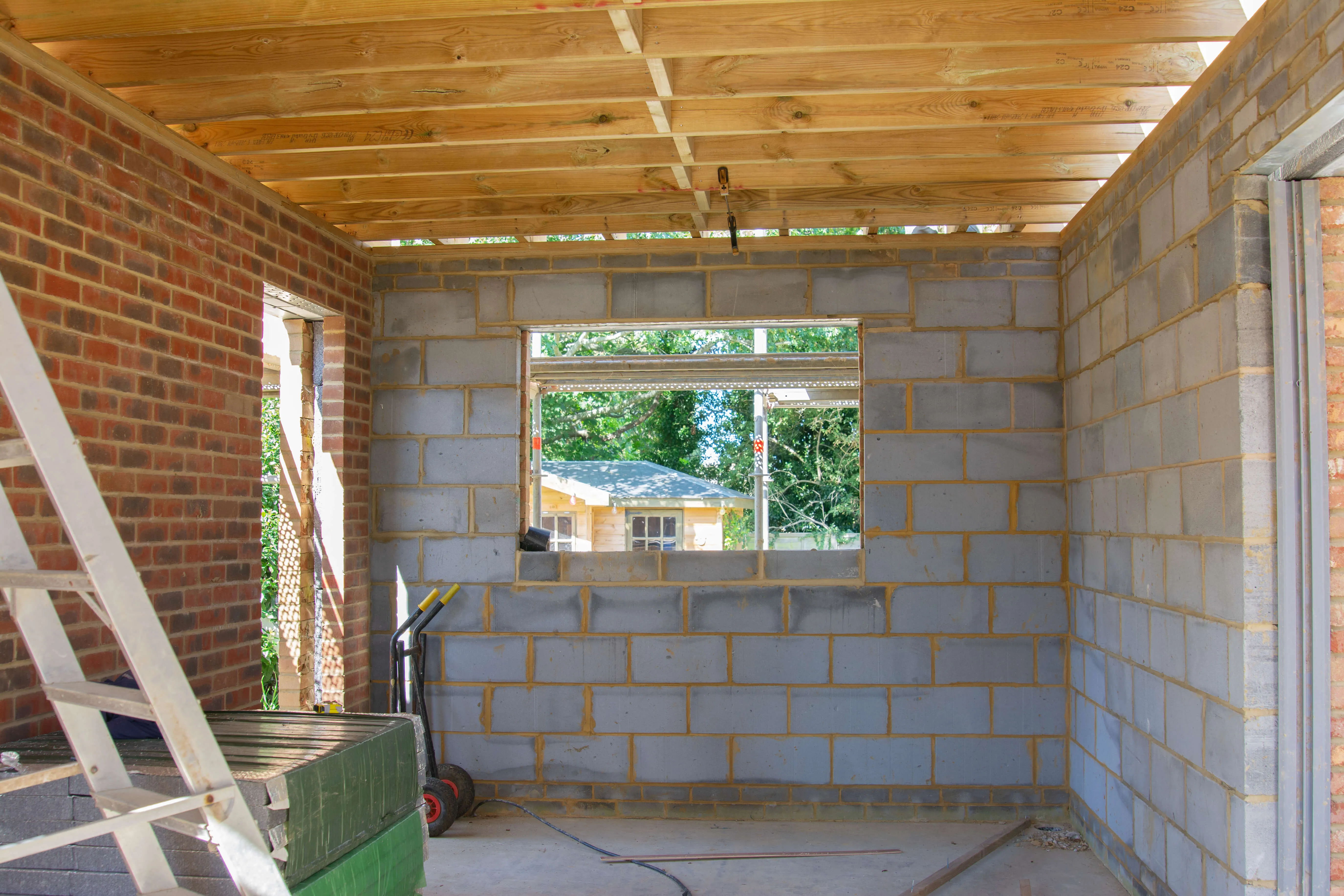 A room that is under construction with a ladder.