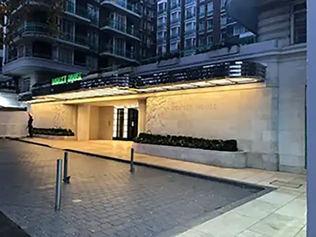 the entrance to a hotel at night time
