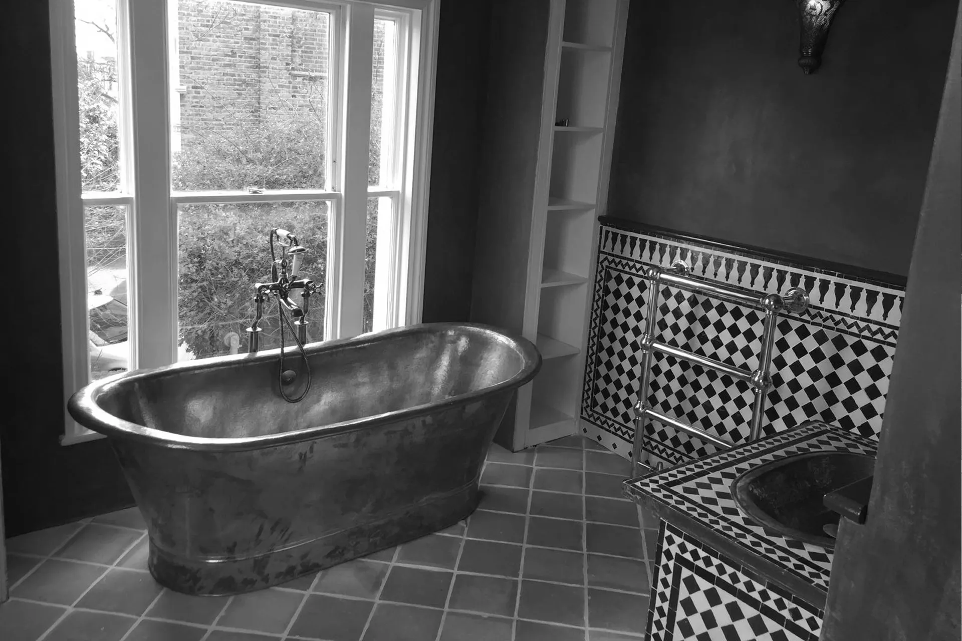 a black and white photo of a bathtub in a bathroom